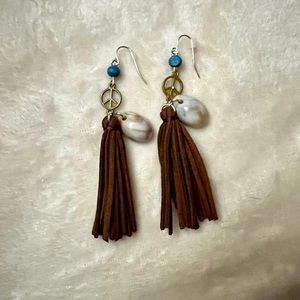 Peace tassel earrings with a shell.